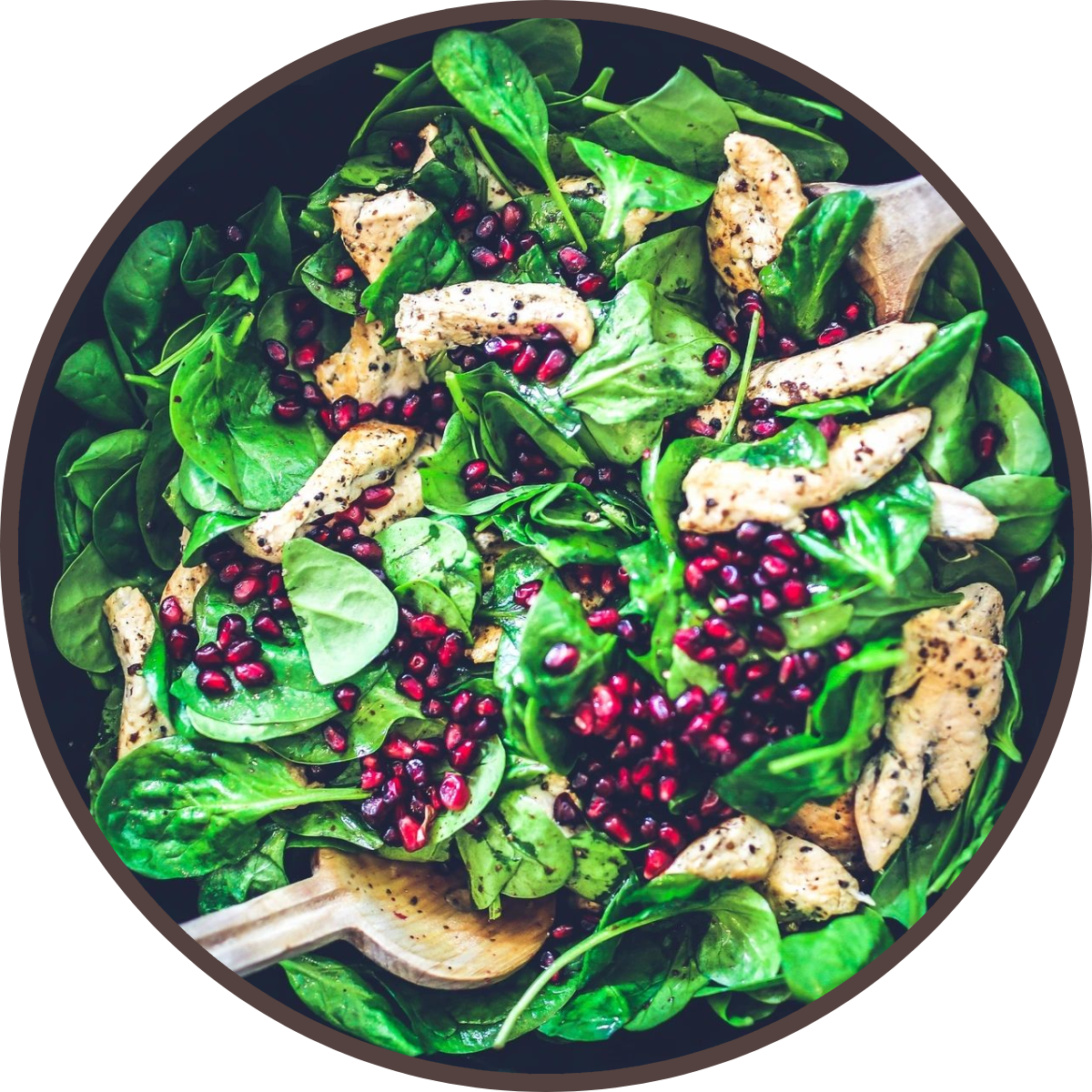 New Project (1) (1) A salad with spinach, chicken and pomegranate seeds.