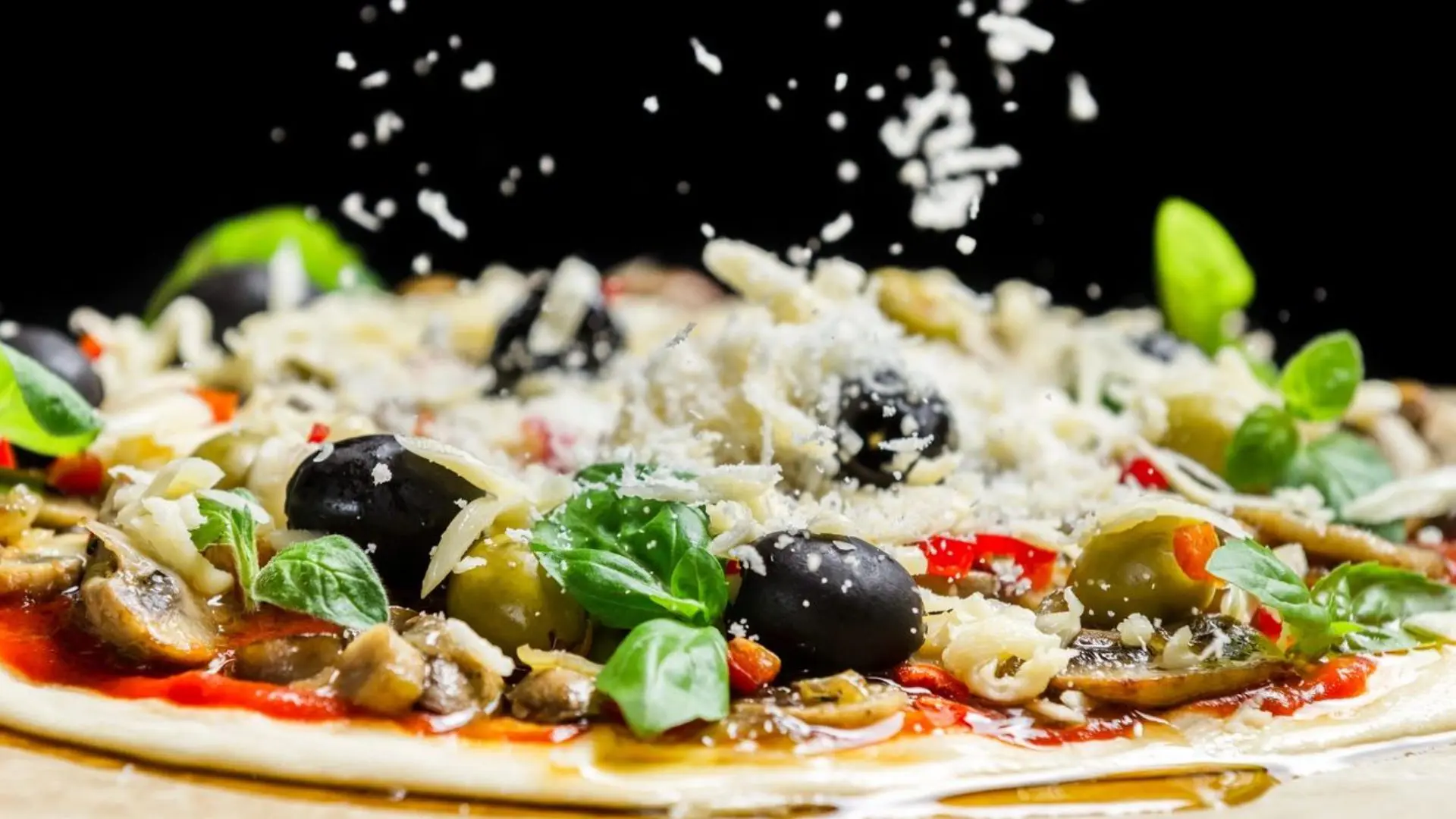 A pizza with olives and cheese on it